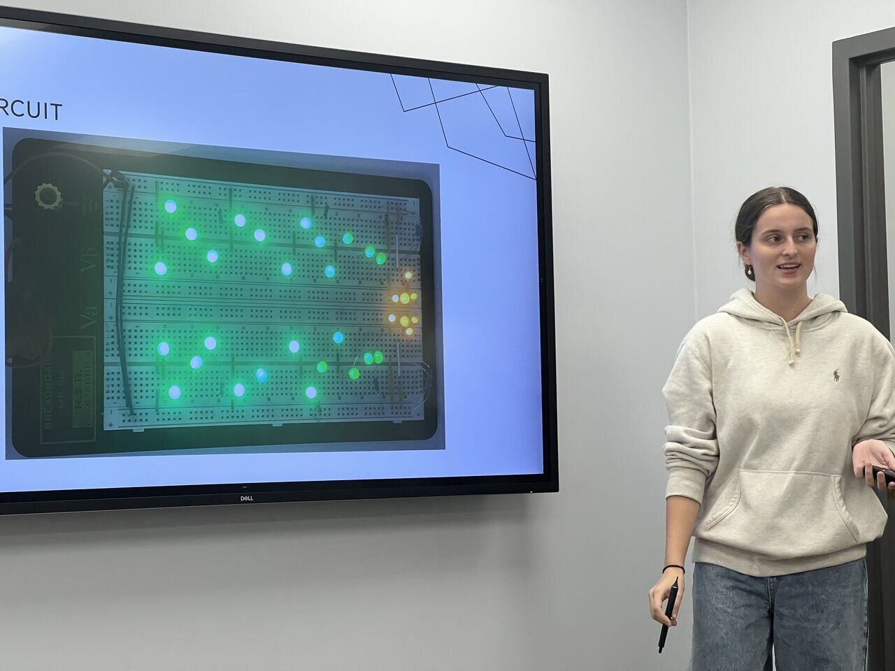 A student presenting a tested breadboard circuit